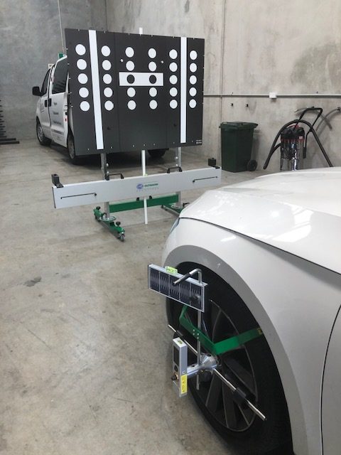 A full ADAS calibration setup — target board, alignment rig and wheel bracket squared to a vehicle in the Buderim workshop