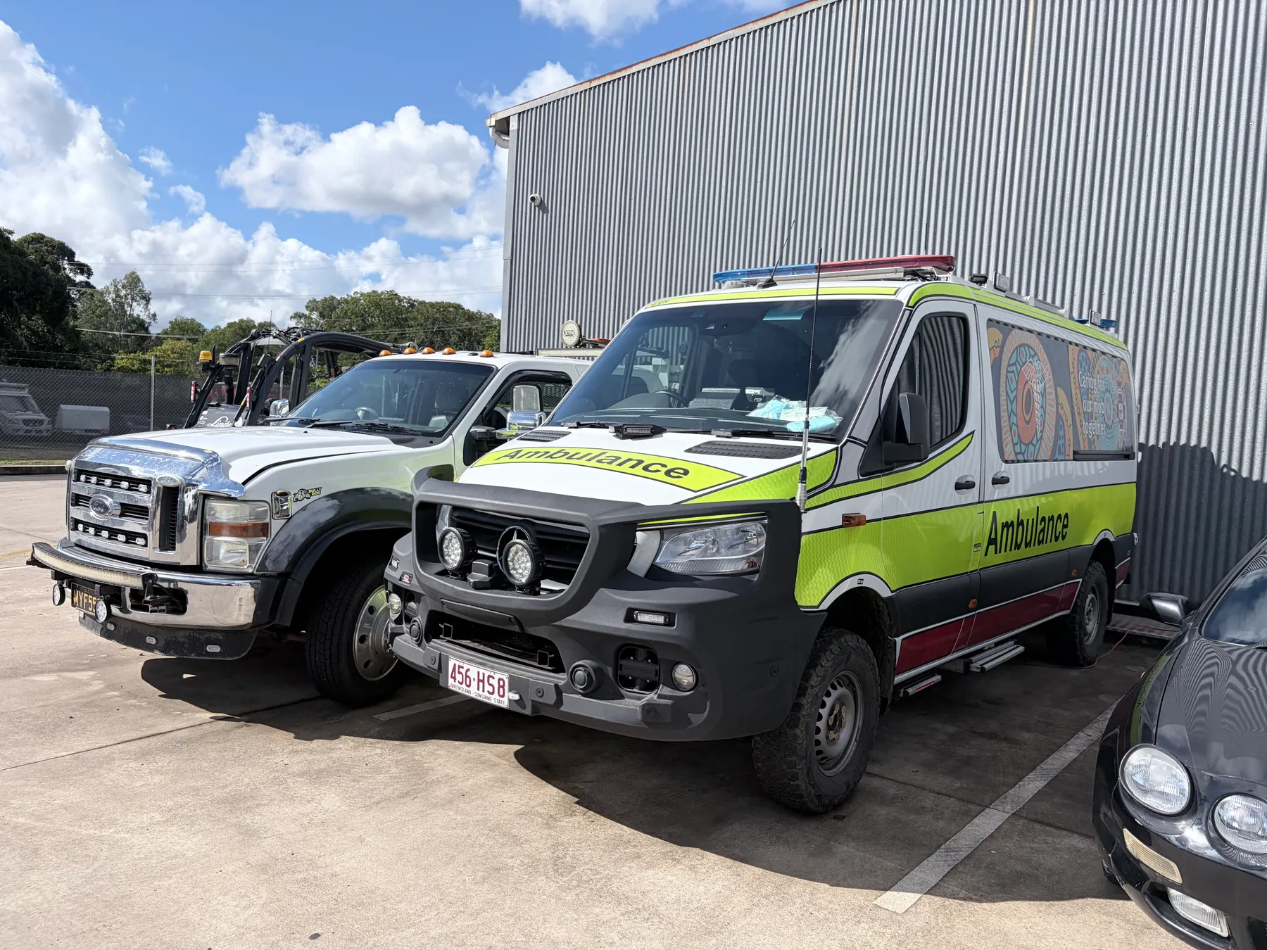 A Queensland ambulance and other fleet vehicles at the Buderim workshop