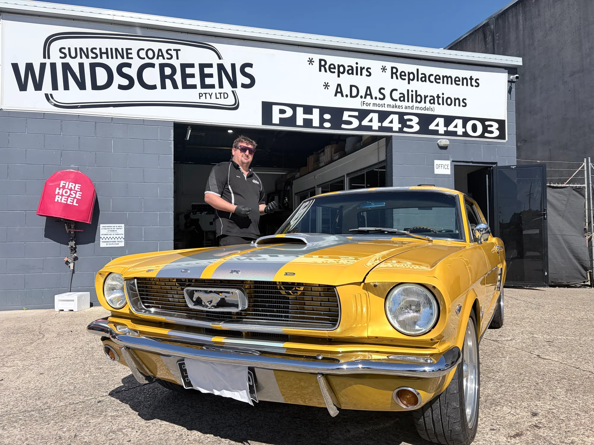 A Sunshine Coast Windscreens technician with a 1966 Ford Mustang in for a windscreen replacement at the Buderim shopfront