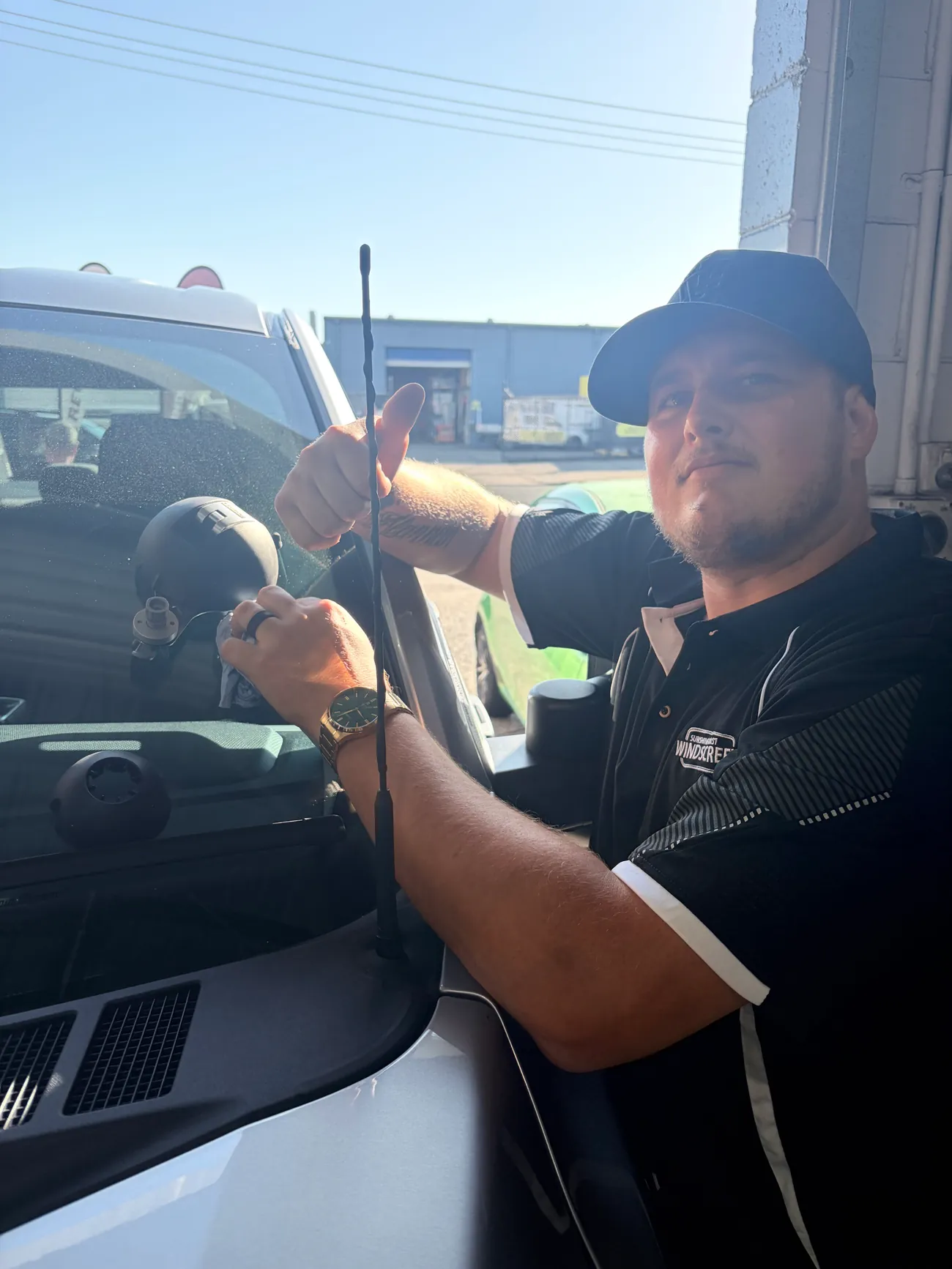 A Sunshine Coast Windscreens technician giving a thumbs up after finishing a windscreen job